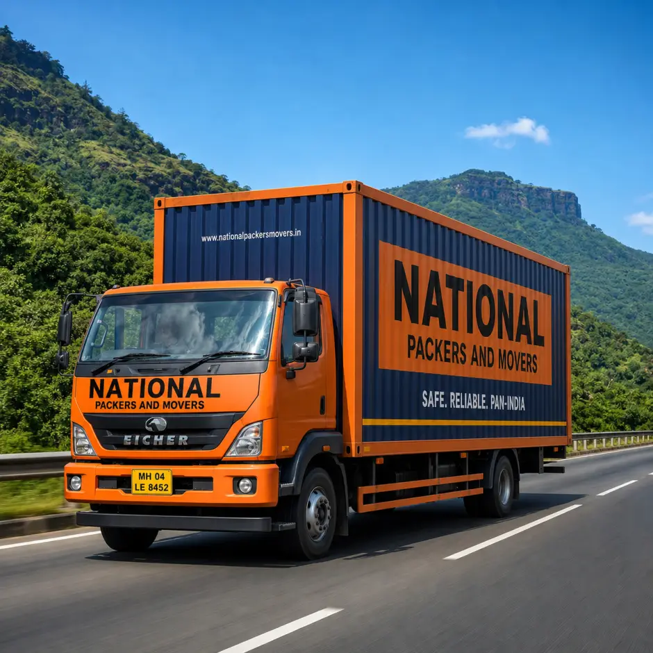 A National Packers and Movers multi-vehicle carrier truck traveling on the Mumbai-Pune Expressway. The orange-and-dark-blue truck carries four cars securely …